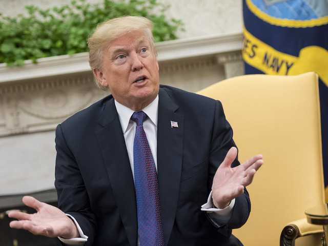 'Trump is treason!': Protester tosses Russian flags at President Trump